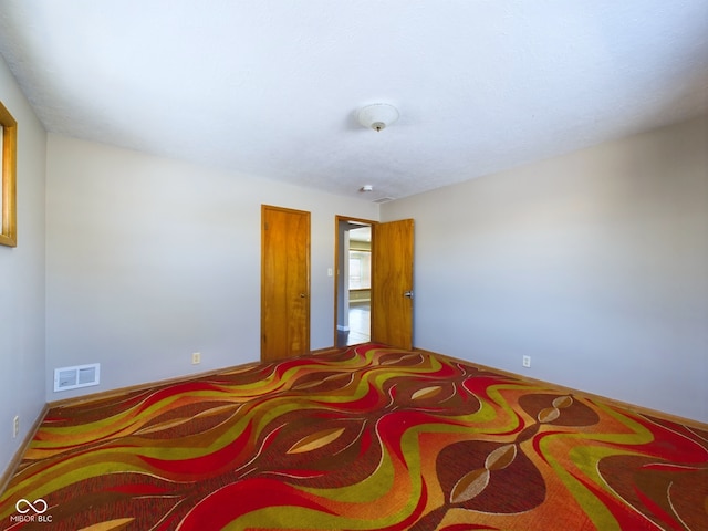 unfurnished bedroom featuring visible vents