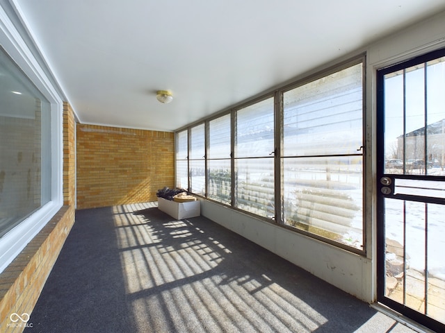 unfurnished sunroom featuring a wealth of natural light