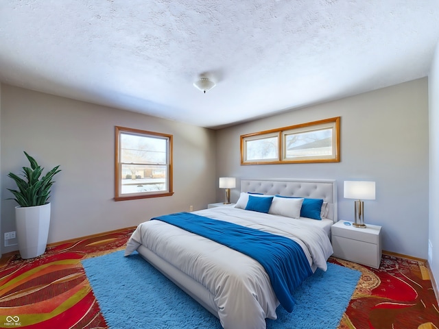 bedroom with multiple windows, a textured ceiling, and baseboards