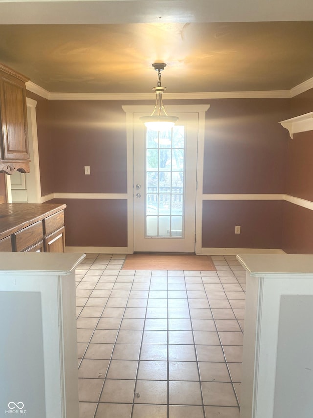 interior space with light tile patterned floors and crown molding