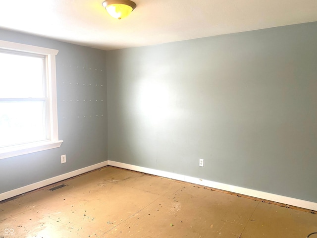 empty room with visible vents and baseboards