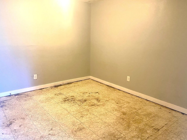 spare room with light floors and baseboards