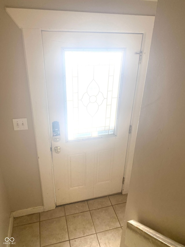 doorway to outside featuring light tile patterned flooring