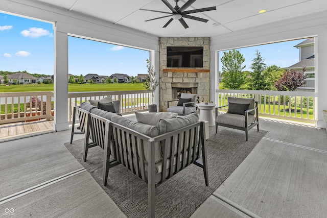 exterior space with a residential view, ceiling fan, and an outdoor living space with a fireplace