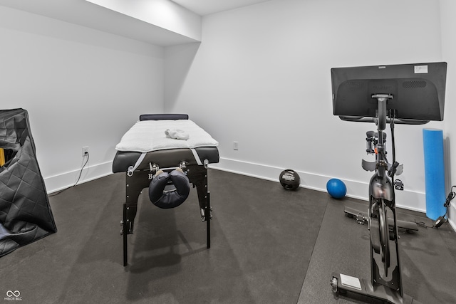 workout room featuring baseboards