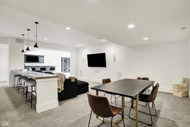 dining area with light carpet, visible vents, baseboards, and recessed lighting