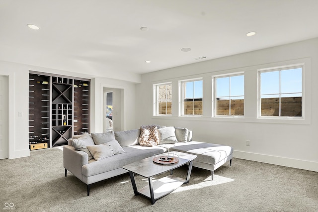 living area featuring visible vents, baseboards, carpet flooring, and recessed lighting