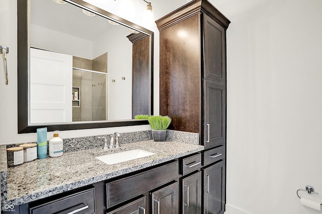 bathroom with a shower stall and vanity