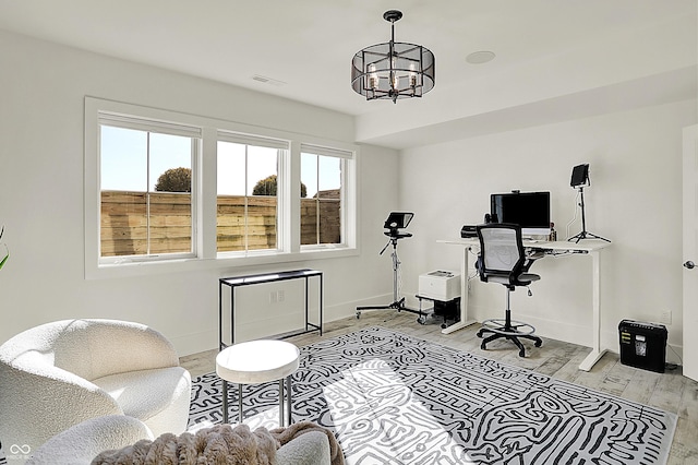 sitting room featuring light wood-style flooring, visible vents, a chandelier, and baseboards