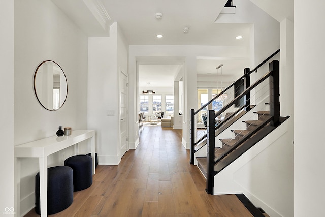 foyer with baseboards, stairway, wood finished floors, and recessed lighting