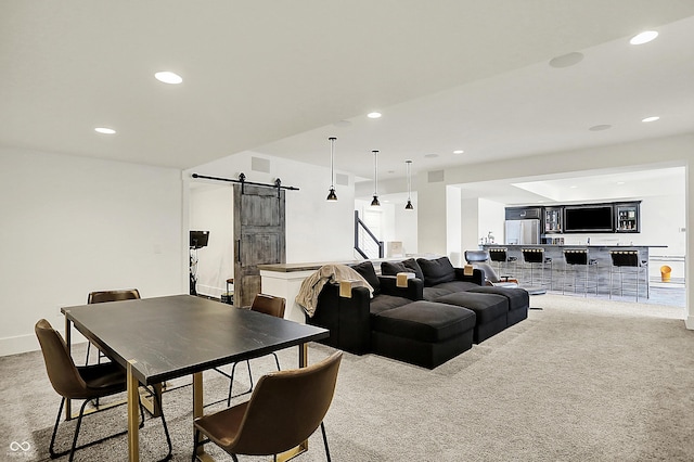 interior space with light carpet, a barn door, visible vents, and recessed lighting