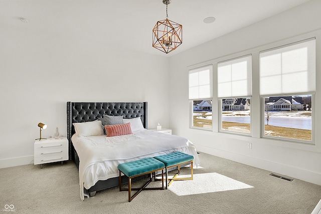 bedroom featuring a notable chandelier, carpet floors, visible vents, and baseboards