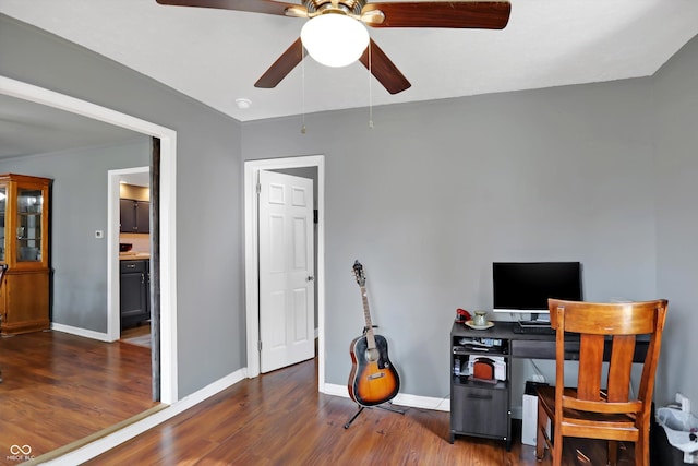 home office featuring baseboards and wood finished floors