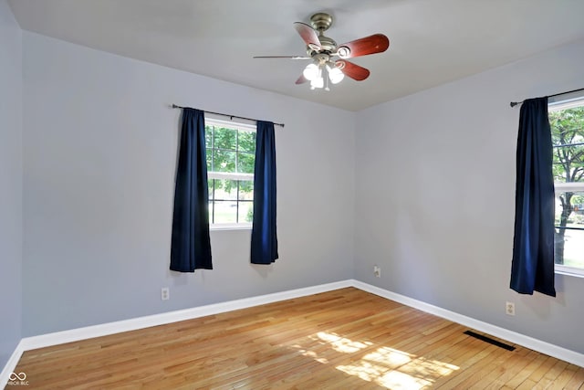 spare room featuring plenty of natural light and baseboards