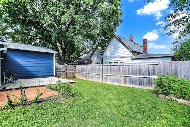 view of yard with a fenced backyard and a wooden deck