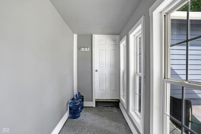 hallway featuring baseboards