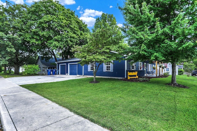 view of front of home with a garage and a front lawn