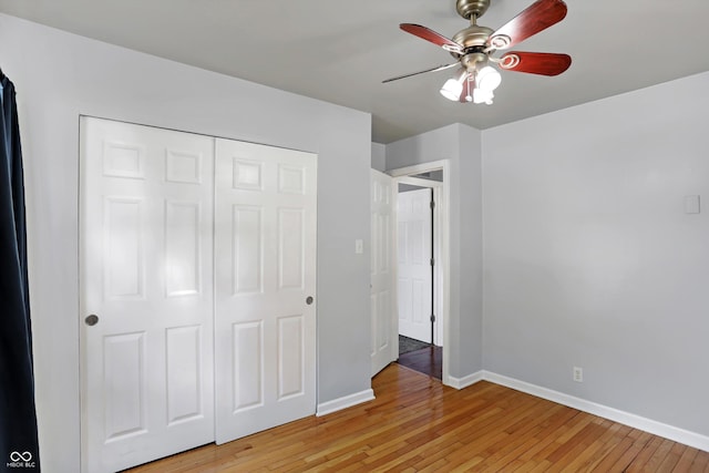 unfurnished bedroom with a ceiling fan, a closet, baseboards, and light wood finished floors