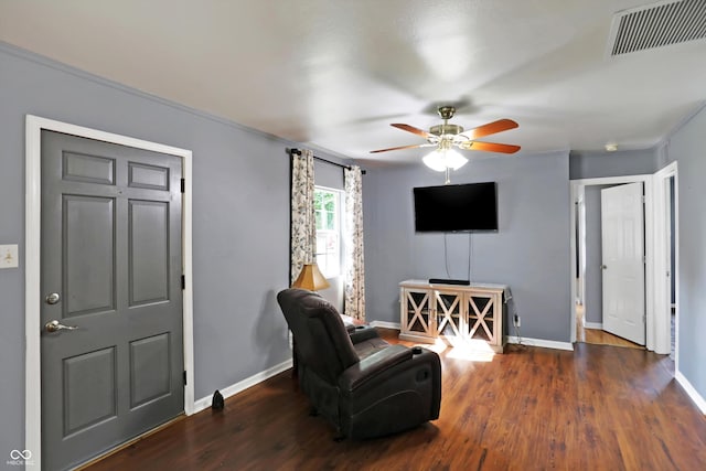 sitting room featuring a ceiling fan, visible vents, baseboards, and wood finished floors