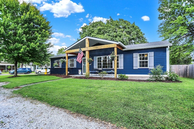 view of front of house with fence and a front lawn