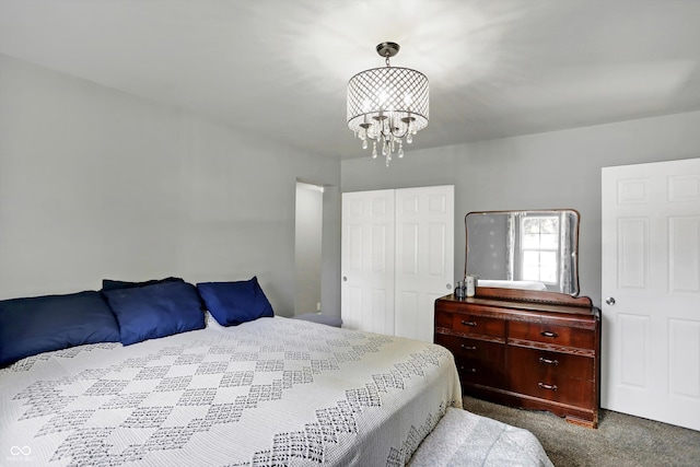 carpeted bedroom with a closet and an inviting chandelier