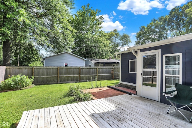 wooden deck with a fenced backyard and a yard