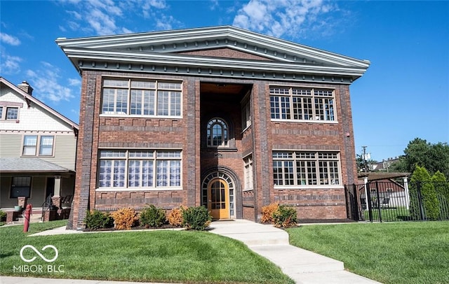 view of front of home with brick siding, fence, and a front lawn