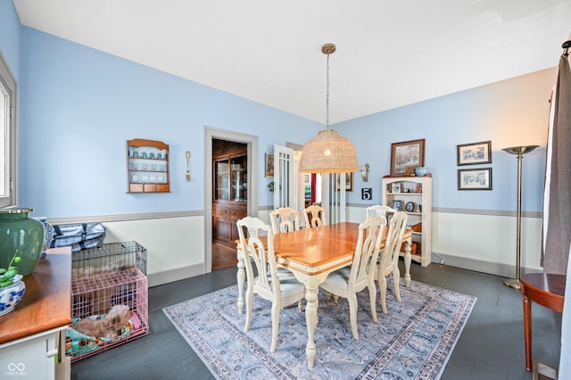 dining room featuring baseboards and wood finished floors