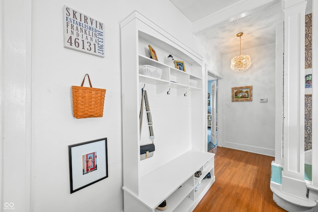 mudroom with baseboards, a chandelier, and wood finished floors