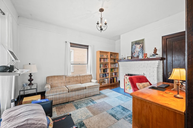 office area with wood finished floors, a fireplace, and an inviting chandelier