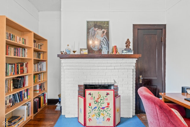 living area with a brick fireplace