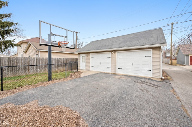 detached garage featuring fence