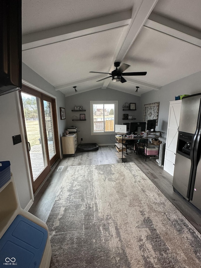 living room with lofted ceiling with beams, wood finished floors, and a ceiling fan