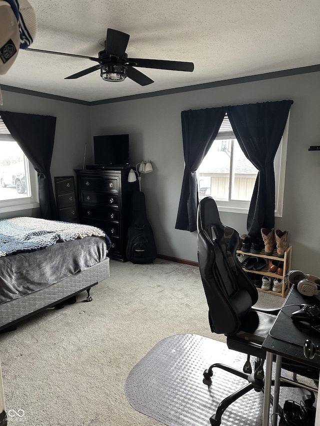 bedroom with a textured ceiling, ceiling fan, ornamental molding, and carpet flooring