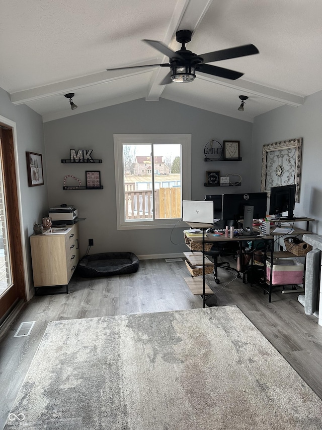 office area with vaulted ceiling with beams, light wood-style flooring, and a textured ceiling