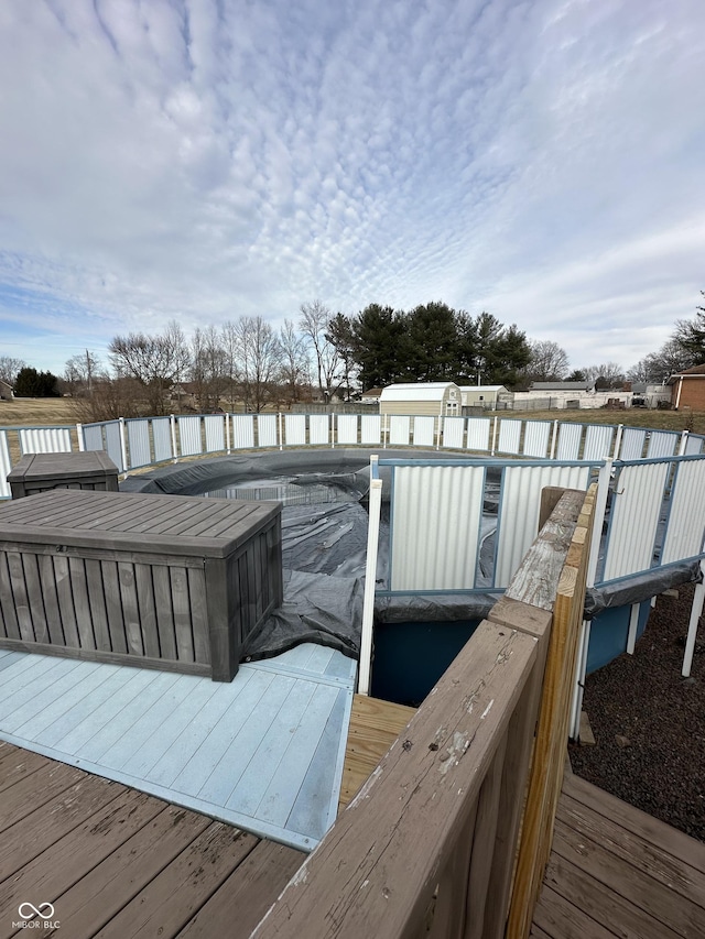 wooden terrace with a fenced in pool