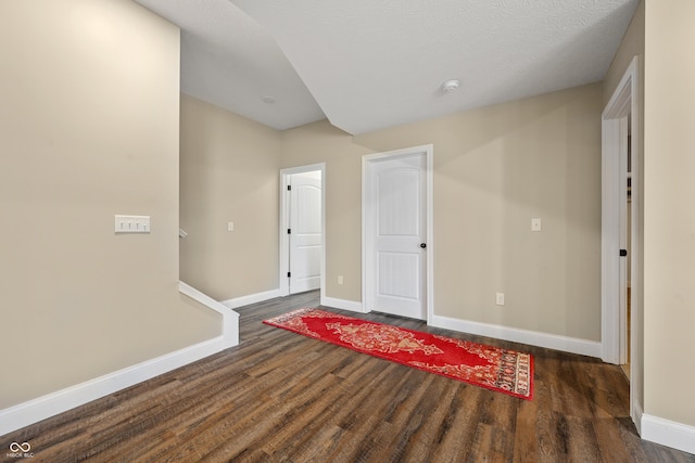 entryway featuring dark wood-style floors and baseboards