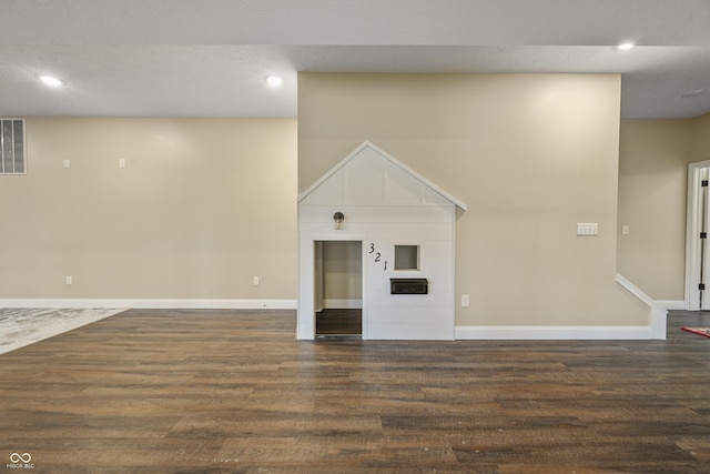 interior space featuring baseboards, dark wood-type flooring, and recessed lighting