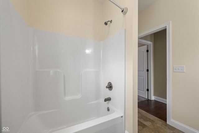 full bath with baseboards and shower / bathtub combination