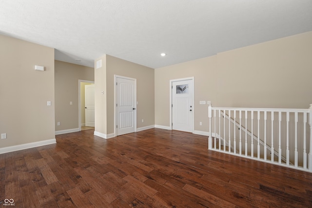 unfurnished room with wood-type flooring and baseboards