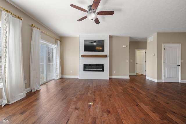 unfurnished living room with a fireplace, visible vents, ceiling fan, wood finished floors, and baseboards