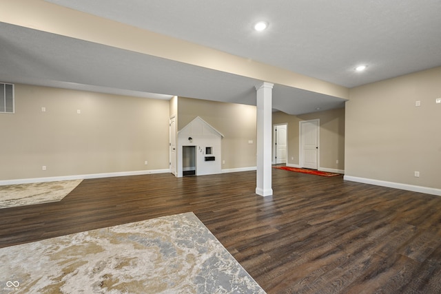 below grade area with recessed lighting, wood finished floors, visible vents, and baseboards