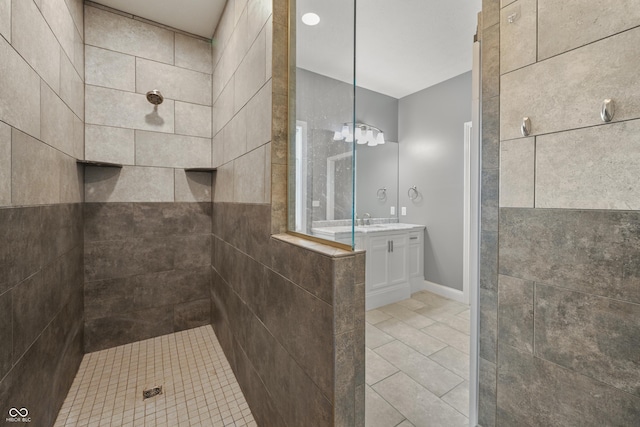 bathroom featuring tile patterned flooring, walk in shower, and vanity