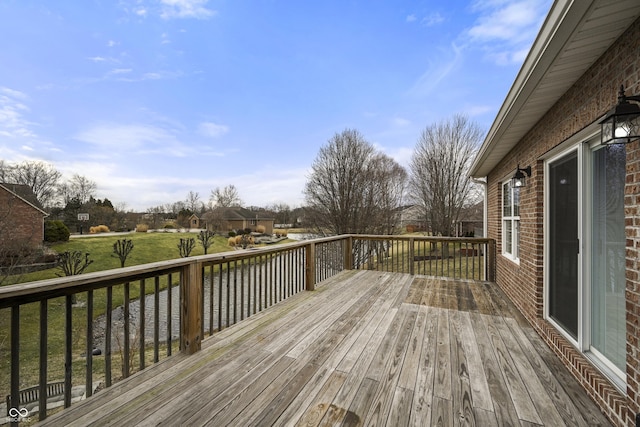 wooden deck featuring a yard