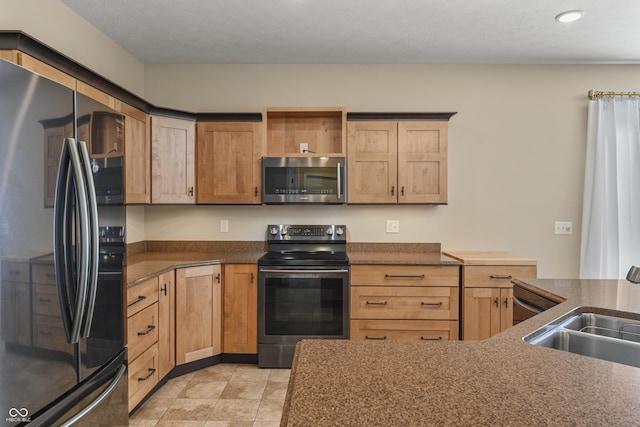 kitchen with dark countertops, open shelves, stainless steel appliances, and a sink