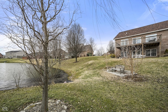 view of yard with a deck with water view