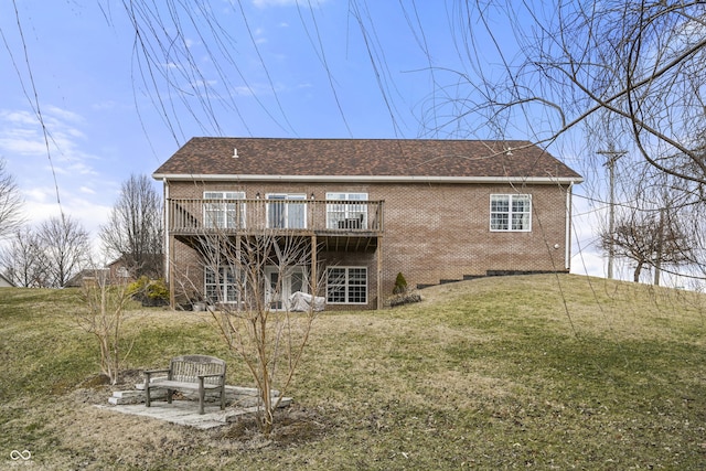 back of house with brick siding, a lawn, and a wooden deck