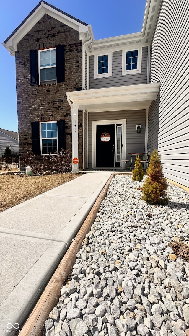 doorway to property with brick siding