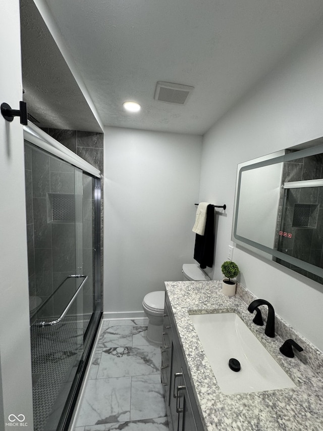 full bath with toilet, vanity, baseboards, marble finish floor, and a shower stall