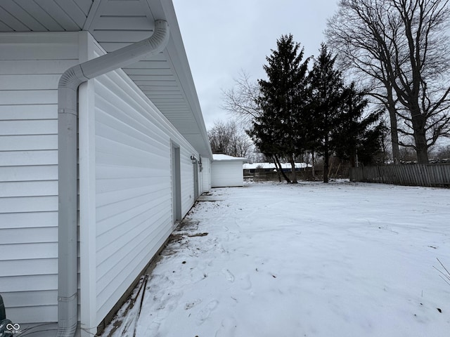 snowy yard with fence